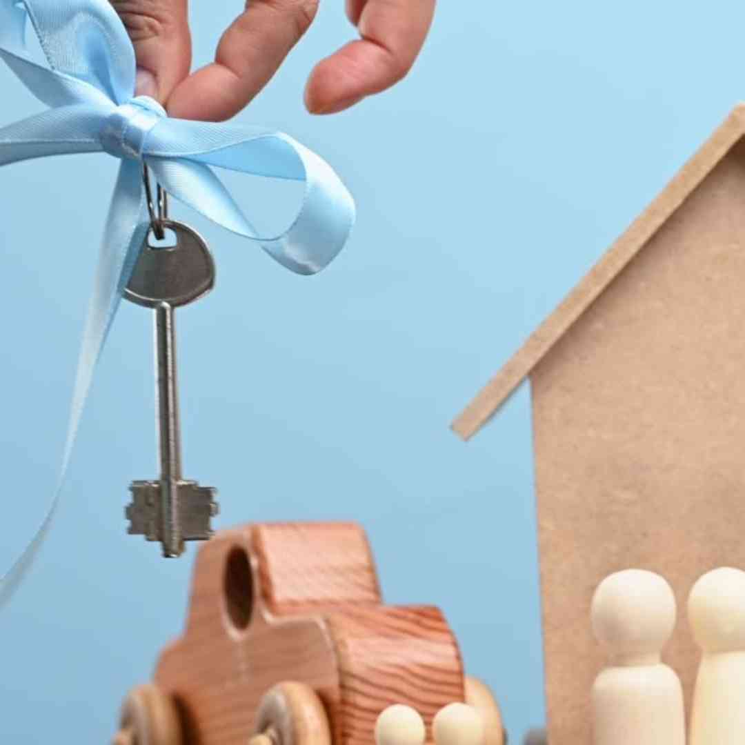Hand holding house keys, representing VA property requirements